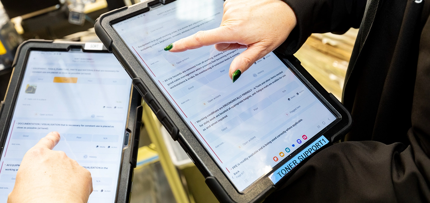 Two employees auditing on a tablet
