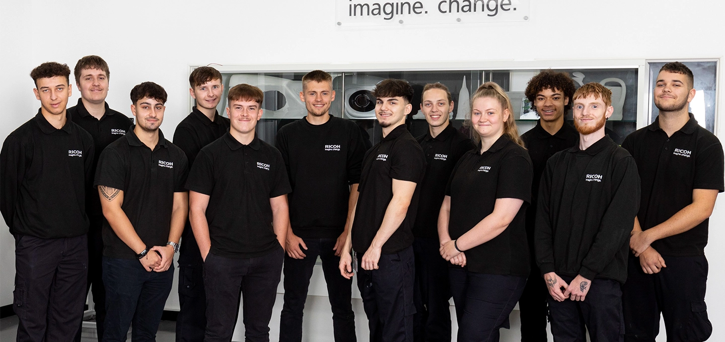 Ricoh UK Products Ltd's (RPL) apprentices pose with their fists in the air, showcasing their teamwork and winning spirit.