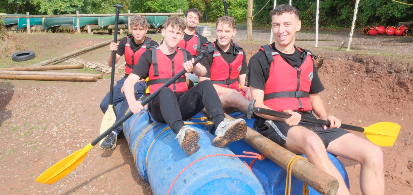 apprentices on their handmade raft