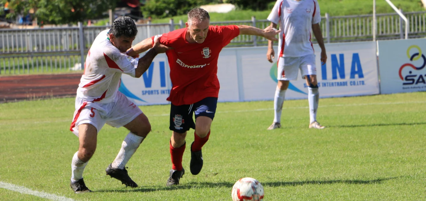 A Ricoh employee playing football for England's veterans team. 